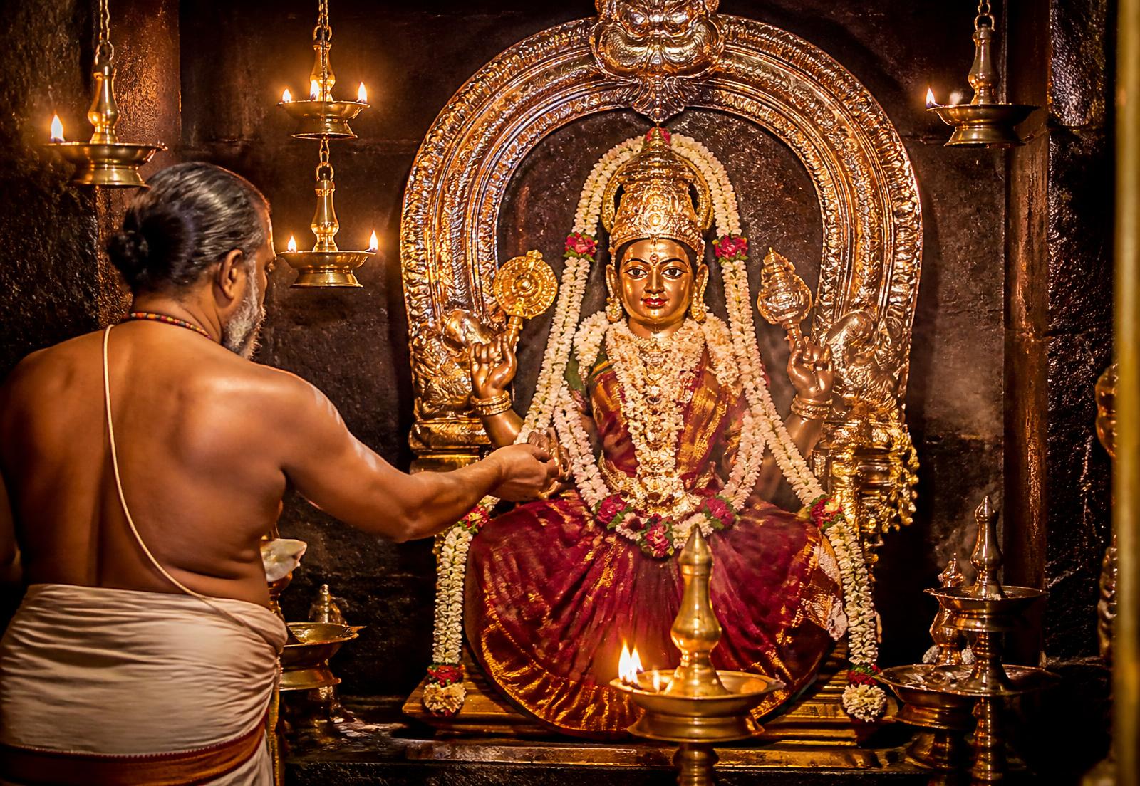 Archaka performing abhishekam for the Devi